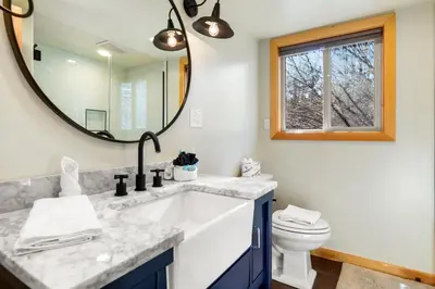 a bathroom with a sink and a mirror at Bear Creek Haven -Nestled between the Village & Lake! in Big Bear Lake