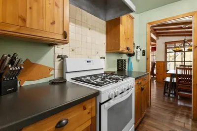 a kitchen with a white stove top oven at Mountain Xscape - Hot Tub, Fireplace, Deck, Barbeque in Big Bear Lake