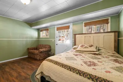 a bedroom with a bed and a chair at Mountain Xscape - Hot Tub, Fireplace, Deck, Barbeque in Big Bear Lake