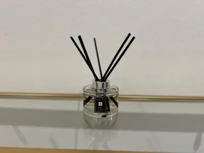 a glass vase with sticks in it on a table at Santa Monica Bright Studio with stunning view in Los Angeles