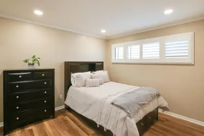 a bedroom with a bed with a black dresser and a window at 10 Mi to Redondo Beach Carson Home with Pool Table! in Carson