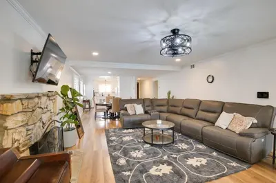 a living room with a couch and a tv at 10 Mi to Redondo Beach Carson Home with Pool Table! in Carson