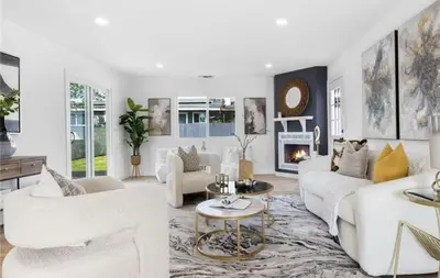 a living room with white furniture and a fireplace at cozy house 4 bedrooms 2 baths in Glendora
