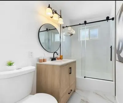 a bathroom with a sink and a toilet and a mirror at cozy house 4 bedrooms 2 baths in Glendora