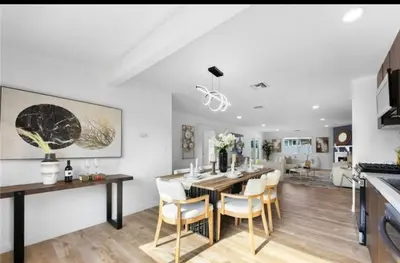 a kitchen and dining room with a table and chairs at cozy house 4 bedrooms 2 baths in Glendora