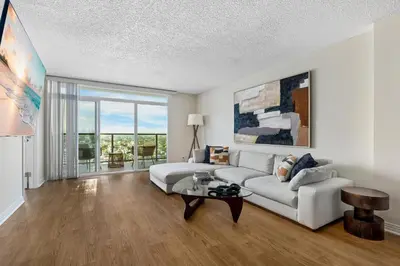 a living room with a couch and a table at A Symphony of Blue - Panoramic Ocean Frontage - 3BR Marina Suite in Los Angeles