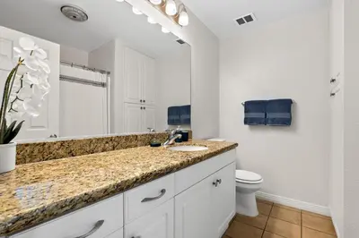 a bathroom with a sink and a toilet at A Symphony of Blue - Panoramic Ocean Frontage - 3BR Marina Suite in Los Angeles