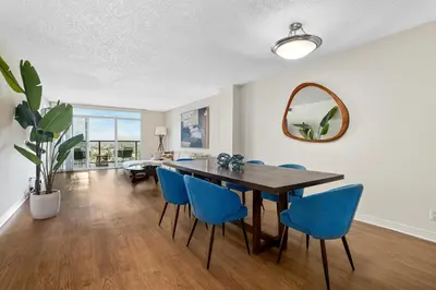 a dining room with a table and blue chairs at A Symphony of Blue - Panoramic Ocean Frontage - 3BR Marina Suite in Los Angeles