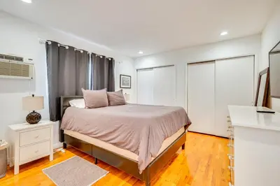 a white bedroom with a bed and a window at 1 Mi to Dtwn Melrose Cozy Condo with Patio in Los Angeles