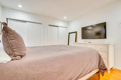 a bedroom with a bed and a flat screen tv at 1 Mi to Dtwn Melrose Cozy Condo with Patio in Los Angeles