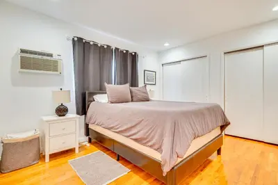 a white bedroom with a bed and a window at 1 Mi to Dtwn Melrose Cozy Condo with Patio in Los Angeles