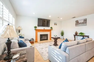 a living room with two couches and a fireplace at Family Oasis in Anaheim
