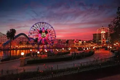 a carnival with a ferris wheel at night at Family Oasis in Anaheim