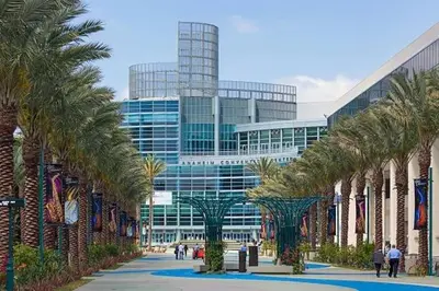 a row of palm trees in front of a building at Family Oasis in Anaheim