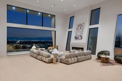 a large living room with couches and a large window at Woodhill Canyon in Los Angeles