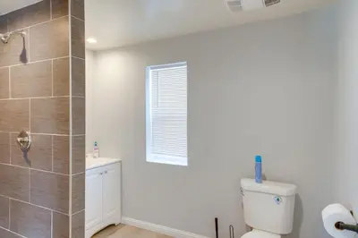 a bathroom with a toilet and a window at 6 Mi to Frazier Mountain Cozy Studio Retreat in Frazier Park