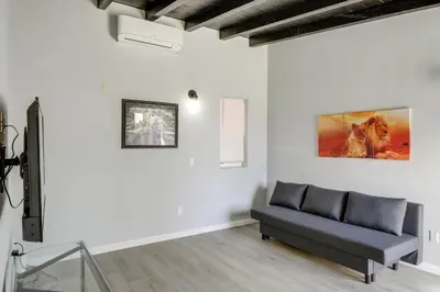 a living room with a couch and a painting on the wall at 6 Mi to Hiking Apartment in Frazier Park in Frazier Park