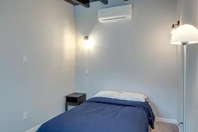 a bedroom with a bed with a blue blanket at 6 Mi to Hiking Apartment in Frazier Park in Frazier Park