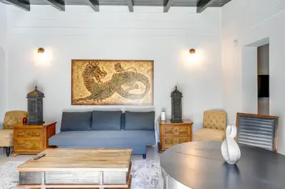 a living room with a blue couch and a table at Hike and Explore Studio Stay in Frazier Park in Frazier Park