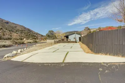 an empty street with a building and a fence at Private Deck and Views Frazier Mountain Cabin in Frazier Park