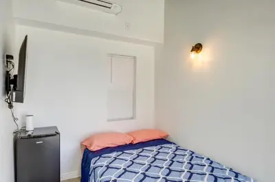a small bedroom with a bed and a window at Mountain Views Minimalist California Studio in Frazier Park