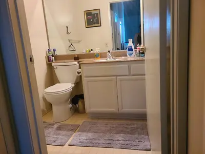 a bathroom with a toilet and a sink and a mirror at Guest Room in Sherman Oaks with private bathroom and balcony in Sherman Oaks