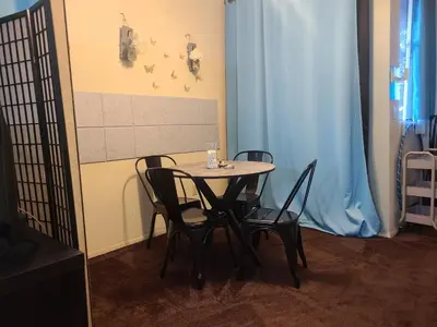 a table and chairs in a room with a blue curtain at Guest Room in Sherman Oaks with private bathroom and balcony in Sherman Oaks