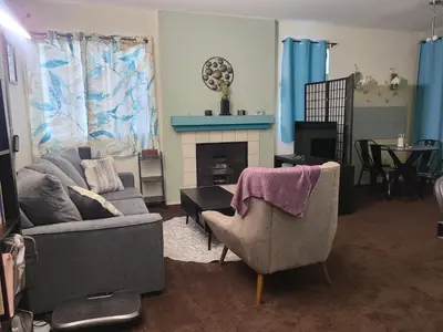 a living room with two chairs and a fireplace at Guest Room in Sherman Oaks with private bathroom and balcony in Sherman Oaks