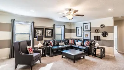a living room with a couch and a ceiling fan at ROM2112 in Los Angeles