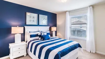 a blue bedroom with a bed and a window at ROM2112 in Los Angeles