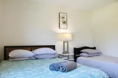 a bedroom with two beds with towels on them at Los Angeles Cherry Blossom in Monterey Park
