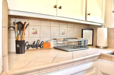a kitchen counter with a dish rack on the wall at Los Angeles Cherry Blossom in Monterey Park