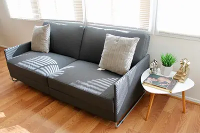 a black couch in a living room with a table at Los Angeles Cherry Blossom in Monterey Park