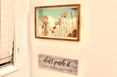 a picture of palm trees on a wall with a sign at Los Angeles Gem in Monterey Park