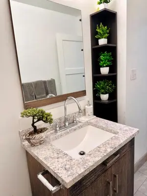 a bathroom with a sink and a large mirror at Los Angeles Gem in Monterey Park