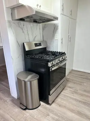 a kitchen with a stove and a trash can at Los Angeles Gem in Monterey Park