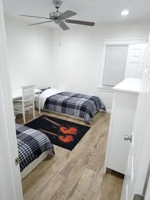a bedroom with two beds and a ceiling fan at Vacation Unit is Available for Business and Family Trip in Long Beach