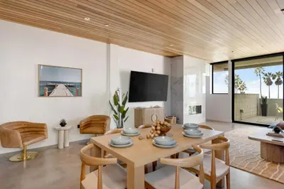 a living room with a wooden table and chairs at The Santa Monica Sunset - 5k sq ft beachfront luxury in Los Angeles
