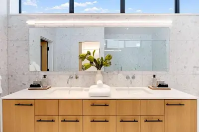 a bathroom with a white sink and a mirror at The Santa Monica Sunset - 5k sq ft beachfront luxury in Los Angeles