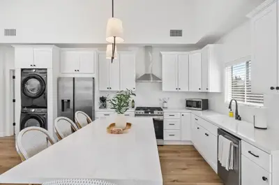 a kitchen with white cabinets and a white counter top at Coastal Modern 3 Bed 2 Bath, Pet Friendly in Hawthorne