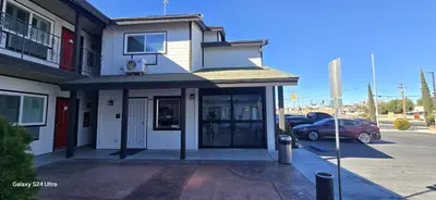 a building with a car parked in a parking lot at Hotel Avenida - Victorville, Hesperia, Apple Valley, I-15 in Victorville