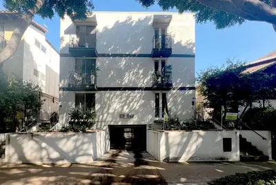a white building with a door in front of it at Seaside Escape Steps from Santa Monica Beach in Los Angeles