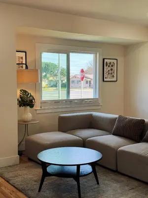 a living room with a couch and a table at Cozy Private Room A in S Central LA in Los Angeles