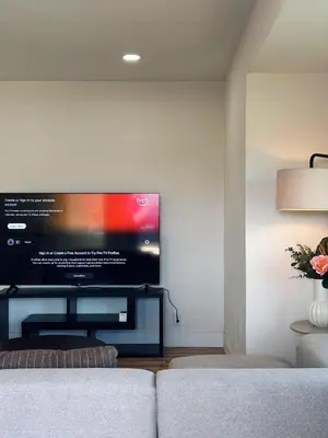 a living room with a large flat screen tv on a wall at Cozy Private Room A in S Central LA in Los Angeles