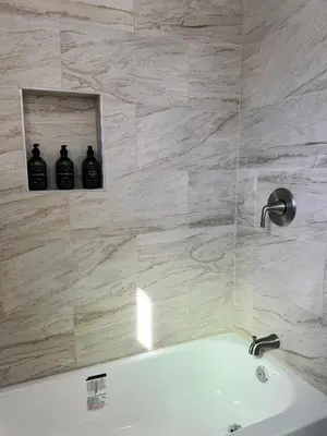 a bathroom with a tub and a mirror and a sink at Cozy private room B in S Central LA in Los Angeles