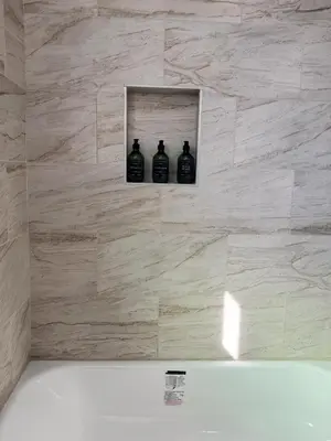 three black bottles sitting on a wall in a bathroom at Cozy Private Room C in S Central LA in Los Angeles