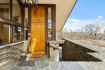 a wooden door on a building with a stone wall at A California Country Experience - Tehachapi in Tehachapi
