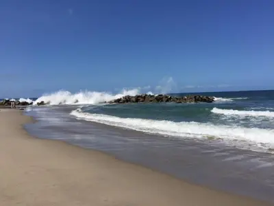 a beach with waves crashing on the shore at Walk to Santa Monica Beach & Pier I Free Parking! in Los Angeles