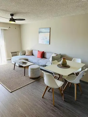 a living room with a couch and a table and chairs at Walk to Santa Monica Beach & Pier I Free Parking! in Los Angeles