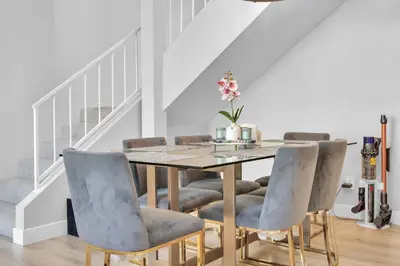 a dining room with a table and chairs at High Ceilings 3BR with Loft-2 Baths Pool & Jacuzzi in Tarzana